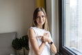 Happy young caucasian woman with blonde hair in white t-shirt showing patch on arm, feeling good after anti coronavirus Royalty Free Stock Photo