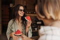 Happy young caucasian woman enjoy eating watermelon relaxing in country house. Royalty Free Stock Photo