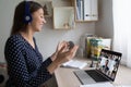 Smiling female employee talk on video call with colleagues Royalty Free Stock Photo