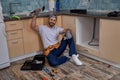 Happy young caucasian worker with raised hand holding hammer Royalty Free Stock Photo