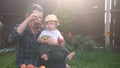 Happy Young Cheerful Mother Holding Baby Eating Fruits On Green Grass. Mom Adorable Infant Child Playing Outdoors With Royalty Free Stock Photo