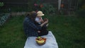 Happy Young Cheerful Mother Holding Baby Eating Fruits On Green Grass. Mom Adorable Infant Child Playing Outdoors With Royalty Free Stock Photo