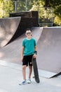 Happy young child boy with skate board on playground and smile. Extreme sport lifestyle. Smiling child with skate board Royalty Free Stock Photo