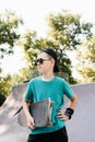 Happy young child boy with skate board on playground and smile. Extreme sport lifestyle. Smiling child with skate board Royalty Free Stock Photo