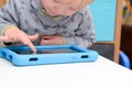 Child using a tablet touch screen device Royalty Free Stock Photo