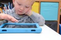 Child using a tablet touch screen device Royalty Free Stock Photo