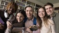 Happy young classmates team having fun in college, university library