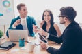 Happy young colleagues having coffee break and talking Royalty Free Stock Photo