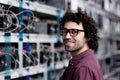 happy young computer engineer at cryptocurrency mining farm looking Royalty Free Stock Photo