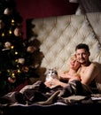 happy young couple in bed at home with their cat Royalty Free Stock Photo