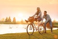 Happy young couple with bicycle having fun. Time for picnic