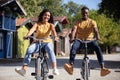 happy young couple with bicycles at summer park