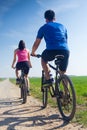 Happy young couple on a bike ride in the countryside Royalty Free Stock Photo