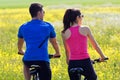 Happy young couple on a bike ride in the countryside Royalty Free Stock Photo