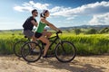 Happy young couple on a bike ride in the countryside Royalty Free Stock Photo