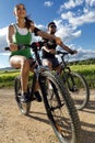 Happy young couple on a bike ride in the countryside Royalty Free Stock Photo