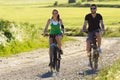 Happy young couple on a bike ride in the countryside Royalty Free Stock Photo