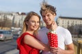 Happy young couple with bouquet smile together outdoors Royalty Free Stock Photo