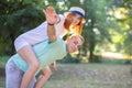 Happy young couple boyfriend and girlfriend having fun outdoors in summer park