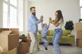 Happy young couple with child having fun in living room in their new home on moving day Royalty Free Stock Photo