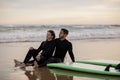 Happy young couple chilling out on the beach after surfing Royalty Free Stock Photo