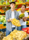 Happy young couple chooses products Royalty Free Stock Photo