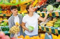 Happy young couple chooses products Royalty Free Stock Photo