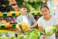 Happy young couple chooses products Royalty Free Stock Photo