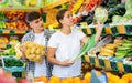 Happy young couple chooses products Royalty Free Stock Photo