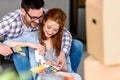 Couple choosing colors for painting home; having fun Royalty Free Stock Photo