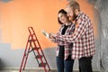 Happy young couple choosing paint colors from palette for new house. Home, moving, decoration, renovation and wall Royalty Free Stock Photo