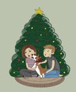 happy young couple with a corgi dog with a red bow around his neck sitting together near the christmas tree at home on a cozy Royalty Free Stock Photo