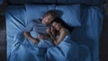 Happy Young Couple Cuddling Together in the Bed Sleeping at Night. Beautiful Girl and Handsome Boy Royalty Free Stock Photo