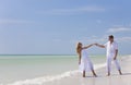 Happy Young Couple Dancing Holding Hands on Beach Royalty Free Stock Photo