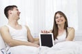 Happy young couple with digital tablet PC