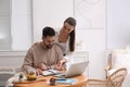 Happy young couple discussing family budget and new house buying at home. Mortgage concept Royalty Free Stock Photo