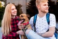 Happy young couple with a dog outdoors.