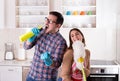 Couple singing and doing chores Royalty Free Stock Photo