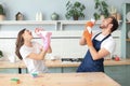 Happy young couple doing home chores, singing and having fun Royalty Free Stock Photo