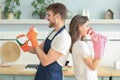 Happy young couple doing home chores, singing and having fun Royalty Free Stock Photo