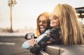 Happy young couple doing road trip in tropical city - Travel people having fun driving in trendy convertible car Royalty Free Stock Photo