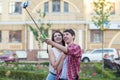 Happy young couple doing selfie by smart mobile phone in the city. Royalty Free Stock Photo