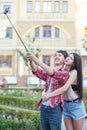 Happy young couple doing selfie by smart mobile phone in the city. Royalty Free Stock Photo