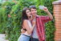 Happy young couple doing selfie by smart mobile phone in the city. Royalty Free Stock Photo