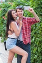 Happy young couple doing selfie by smart mobile phone in the city. Royalty Free Stock Photo