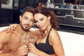 Happy young couple drink champagne in jacuzzi honeymoon Royalty Free Stock Photo