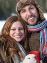 Happy young couple drink warm tea at winter Royalty Free Stock Photo