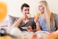 Happy young couple drinking coffee and orange juice Royalty Free Stock Photo