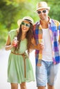 Happy young couple drinking juice and walking Royalty Free Stock Photo