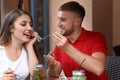 Happy young couple eating in cafe outdoors Royalty Free Stock Photo